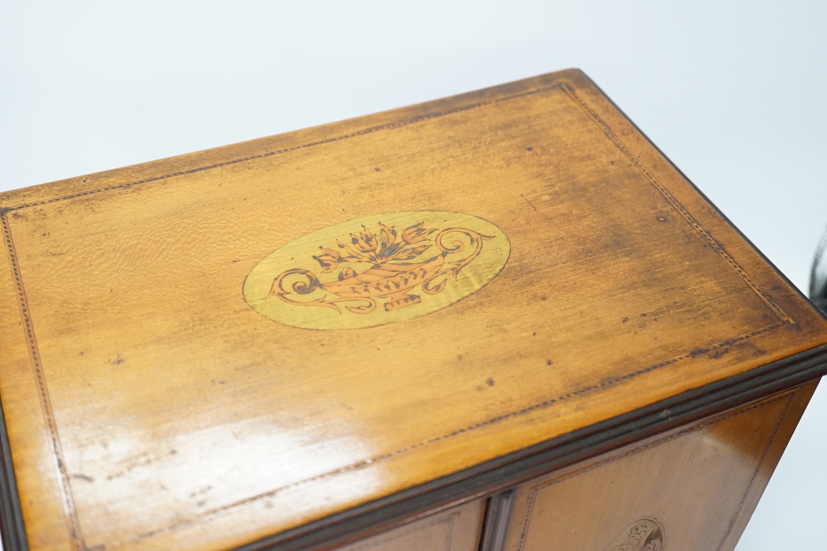 An Edwardian inlaid sycamore two door jewellery chest, 29cm high x 31cm wide